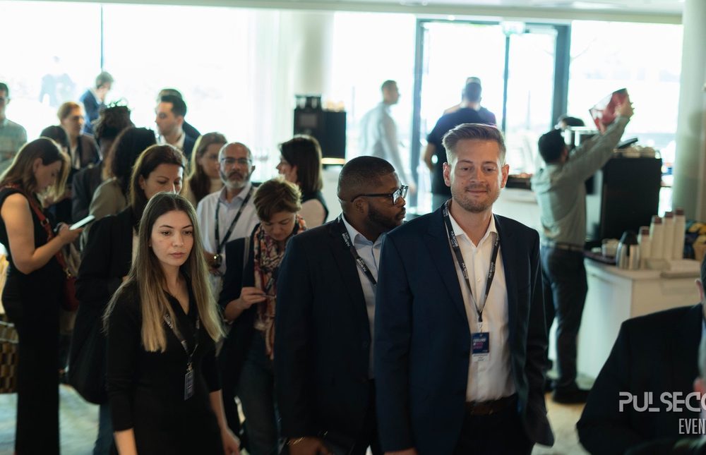 Delegates standing and talking in a bright conference foyer at a previous Excellence in Digital Banking summit
